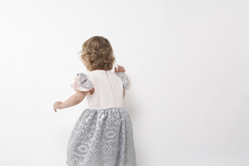little girl in a silver dress