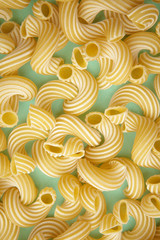 background of pasta in the form of tubes spun in a spiral