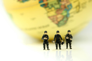 Miniature people : soldiers team with world map,War, army, military, guard concept.