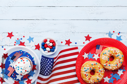Happy Independence Day 4th july background with american flag and sweet foods, decorated with stars and confetti. Top view.