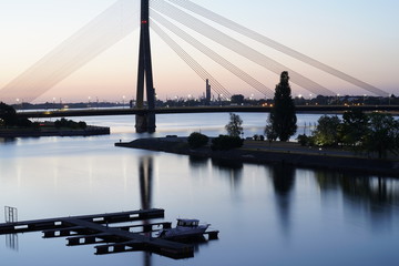 Obraz premium Landscape of a bridge in Riga, Latvia and the Daugava river at night