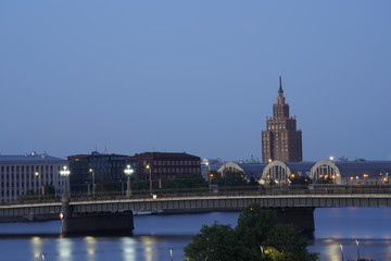 Fototapeta premium Landscape of a bridge in Riga, Latvia and the Daugava river at night