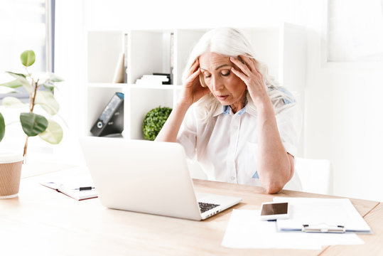 Confused Mature Woman Using Laptop Computer.