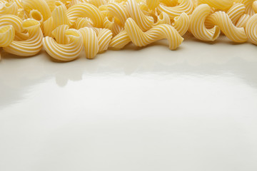 Group of macaroni pasta on gray background