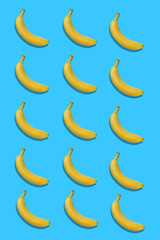 Fototapeta na wymiar Yellow bananas pattern isolated on blue background