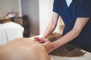 Therapist massaging patient at wellness spa
