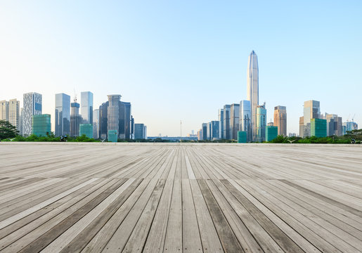 Wood floor square and modern city skyline in Shenzhen,China
