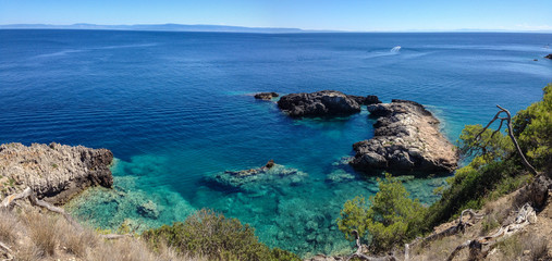 Rocks by the sea with crystal clear water.