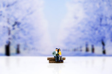 Miniature people : Couple of love with snow winter background,Lover concept.