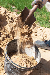 sand shoveling in a bucket