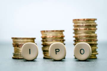 IPO letter blocks  and stacked coins. IPO stands for Initial Public Offering.
