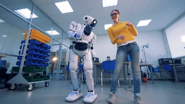 A robot spanks a woman on the buttocks, then she gives it a slap. 4K.