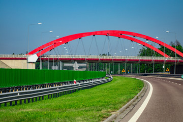 Highway interchange with bridge and sun on the background