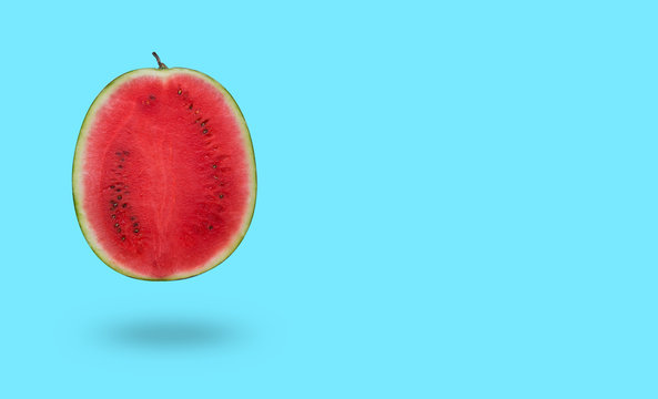 Cutted watermelon isolated on blue background with a shadow and copy space