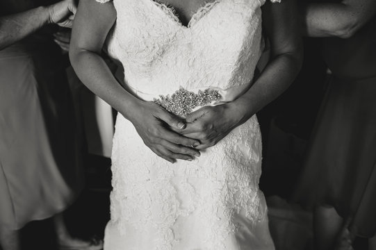Close up of bride hands dressing