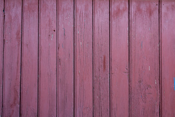 Old vertical pink wooden planks outdoors. Vintage rustic background texture.