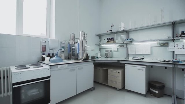 Small white bright chemical laboratory for testing fresh milk products at modern milk factory