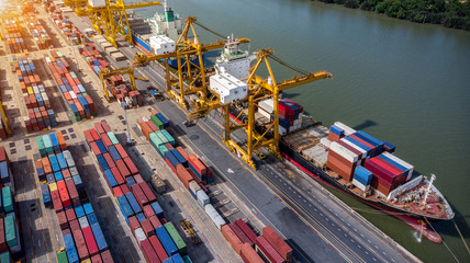 Logistics and transportation of Container Cargo ship and Cargo plane with working crane bridge in shipyard at sunrise, logistic import export and transport industry background