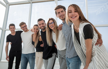 group of successful young people standing in the office
