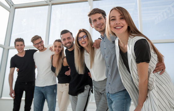 group of successful young people standing in the office