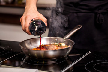 oncept of the correct cooking of meat. The chef prepares, fries a steak of mutton, pork or veal in...