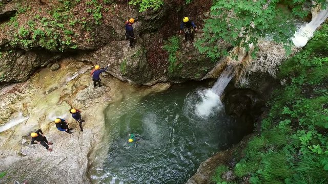 Aerial view of group of people jumping into the water at Soca river, Slovenia.