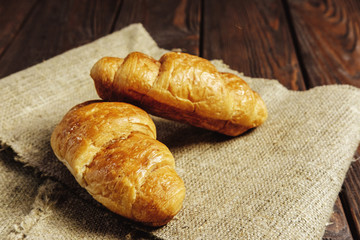 croissants on wooden table black background
