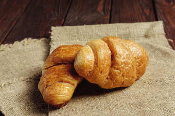 croissants on wooden table black background