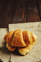 croissants on wooden table black background