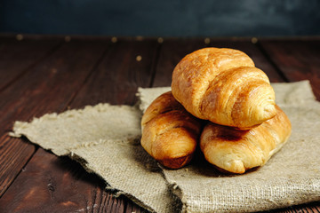 croissants on wooden table black background