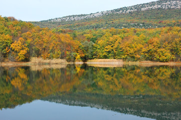 Autumnal landscape with lake and hills