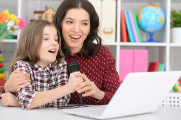mother and daughter singing karaoke