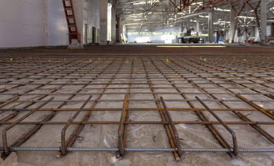 reinforcement frame of the floor prepared for pouring concrete in an industrial room