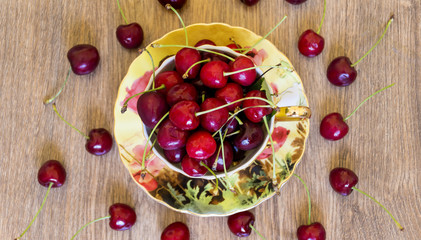 Fresh Cherry in a Cup on Wooden Background. Fresh Ripe Cherries. 