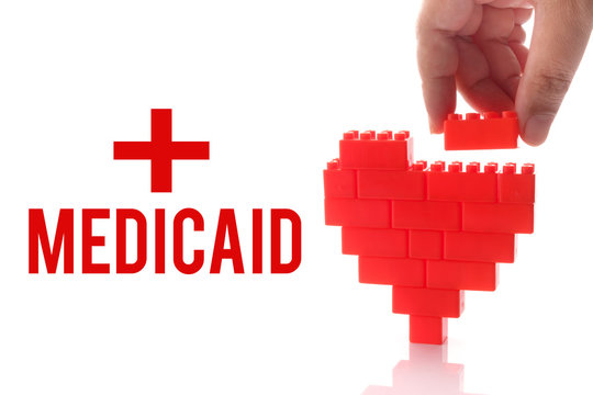 Medicaid, health conceptual. Hand help building heart, symbol of good health.