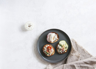 Toasts with mashed avocado and cucumber on white plate. Top view. Healthy eating, dieting, cleansing concept
