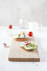 Top view of Healthy Sandwich toast with lettuce, ham, cheese and tomato on a wooden background