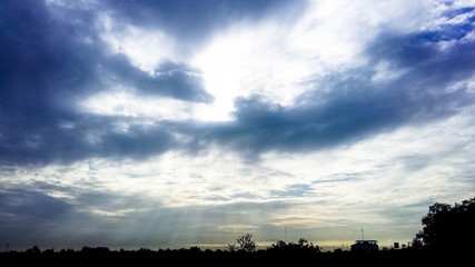 sun and sky with clouds background, Landscape rays of the sun through white clouds against a blue sky, bautiful sunset. Sun rays make their way through the clouds during the sunset against