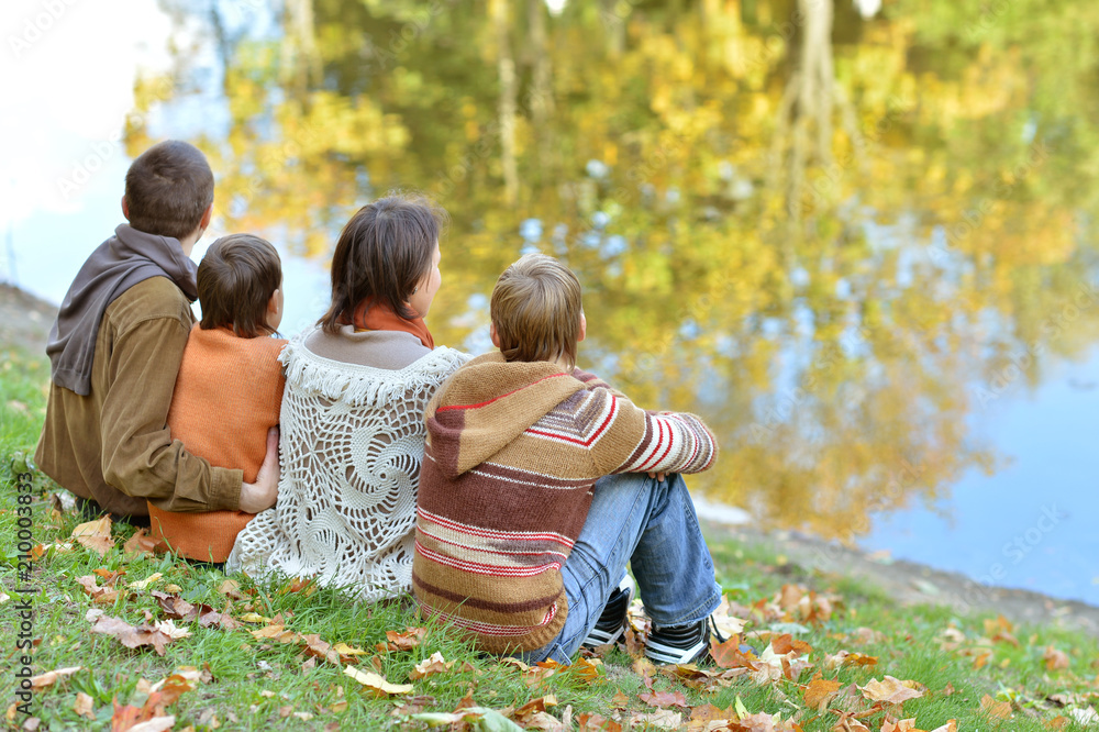 Poster family of four in park