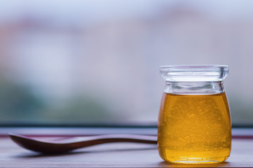 Honey in glass jar closeup,