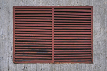 Iron brown closed window on concrete texture urban rough structure