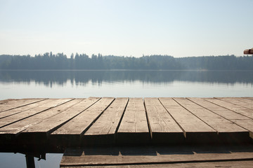 Fototapeta na wymiar Views of forest lake and wooden Board background