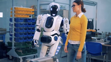 A robot spanks a woman in dance.