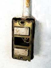 old power supply, electric equipment damage on white wall cement background. Not safety and dangerous when use at home or building.