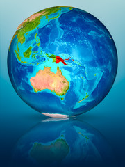 Papua New Guinea on Earth on reflective surface