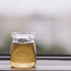Honey in glass jar closeup,