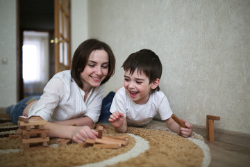 Little boy having fun with  mother at home