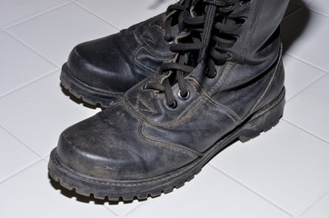 military boots black on the lock and with rivets, sole with a pattern, legs for protection of legs