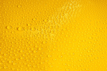natural water drops on yellow background texture