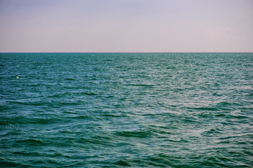 the blue ocean with dull clouds on a lovely sunny day